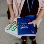 The woman is holding books in her hands